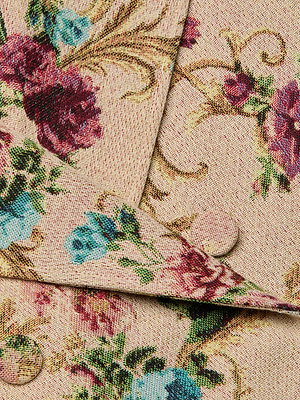 Close-up of the Xoey Cropped Trench Coat, featuring vintage romance with red, blue, and burgundy floral tapestry and green leaves on beige fabric. Layered textile design with two covered buttons adds extra charm.