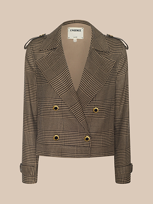 The Xoey Cropped Trench Coat features a double-breasted plaid design with gold buttons, wide lapels, and cuffed sleeves, channeling modern elegance. Shown on a beige background, its label reads “L’AGENCE.”.