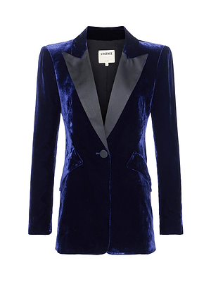 The Sheila Velvet Longline Blazer by L'AGENCE is a single-breasted, midnight-blue velvet jacket with black satin lapels, one-button closure, and two front pockets—ideal for power dressing.