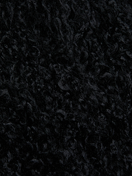 Close-up of the Aura Cropped Faux Fur Jacket in black, showcasing its dense and soft curly textured fabric that resembles shag faux fur.