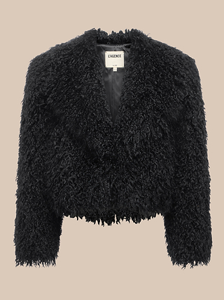 Aura Cropped Faux Fur Jacket featuring a black shag design with a textured, curly finish, long sleeves, and a notched collar, displayed against a neutral beige background.