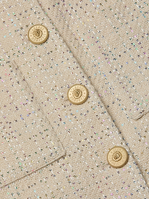 Close-up of ecru tweed with colorful specks and four gold crest-embossed buttons on the Jia Sequined Tweed Jacket by L'AGENCE Sale—an elegant choice for a three-quarter sleeve look.