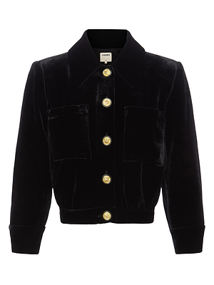 The Jia Velvet Jacket by L'AGENCE is a cropped black velvet jacket featuring a collar, two front pockets, three-quarter sleeves, and five gold buttons down the front.