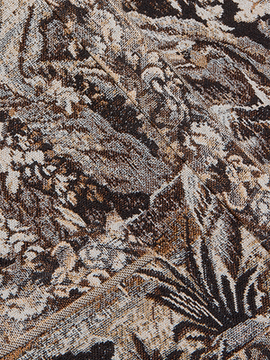 Close-up of the Lian Tapestry Jacket’s brown, black, and beige fabric, showcasing an Italian jacquard with nature-inspired woven textures and abstract leaf motifs.