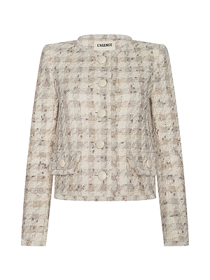 The L’AGENCE Zell Houndstooth Tweed Jacket is a women’s light beige and gray wool-blend piece with a textured tweed finish, long sleeves, round neckline, large front buttons, and two small front pockets. The brand label appears at the collar.