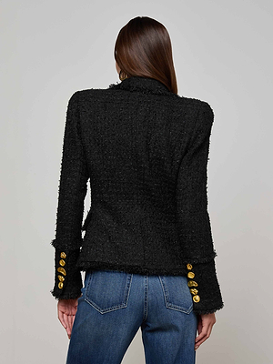 A person with straight brown hair is shown from the back, wearing the L'AGENCE Kaisley Frayed Trim Blazer and a pair of blue jeans.