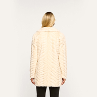 Back view of a person wearing a cream-colored Toira Faux Fur Coat in a 70s-inspired chevron pattern.