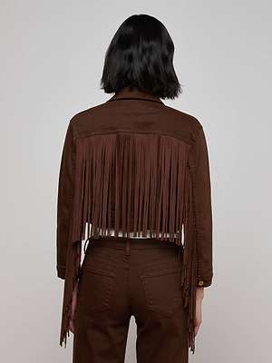 A person with short, dark hair is shown from behind, wearing the Koda Fringe Jean Jacket in chocolate, paired with matching brown pants against a plain light background.