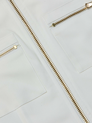 Close-up of the Calianna Shirt Jacket by L'AGENCE, featuring two gold zippers, two rectangular pockets, and a symmetrical geometric pattern on sleek stretch suiting fabric.