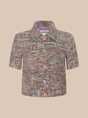 The Chita Tweed Jacket is a cropped, short-sleeved style in multi-colored tweed with a pointed collar and large round buttons down the front, shown against a plain beige background.