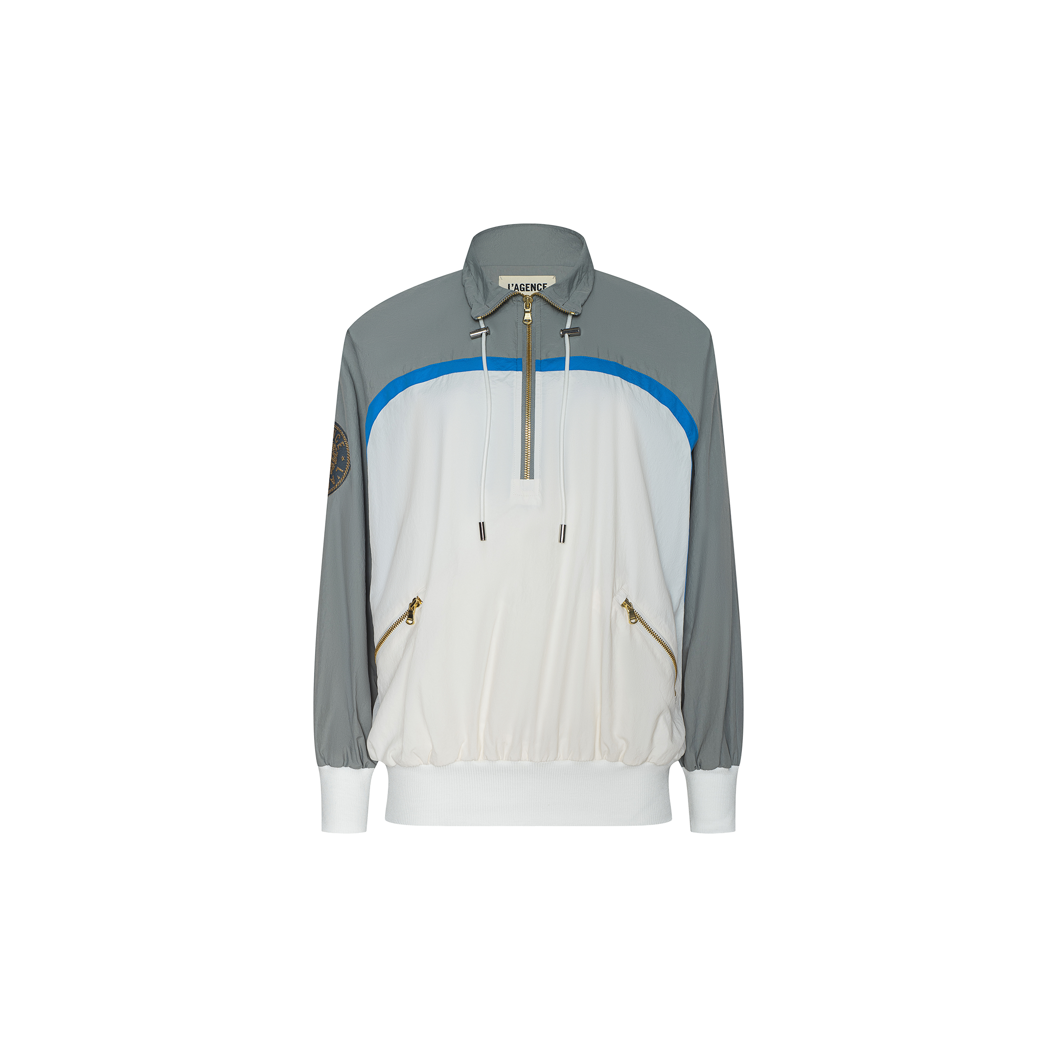 The Aurelia Windbreaker is a long-sleeve, color-block nylon jacket featuring grey shoulders and sleeves, a white front, blue accent, gold zippered pockets, and a half-zip collar. Displayed on a plain white background, this retro windbreaker combines athleisure style with practical design.