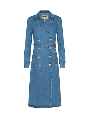 The Bradley Trench Coat is a long, medium-wash blue denim trench with a notched collar, double-breasted buttons, matching waist belt, buttoned cuffs, white stitching, and a structured silhouette. Made from lightweight denim.