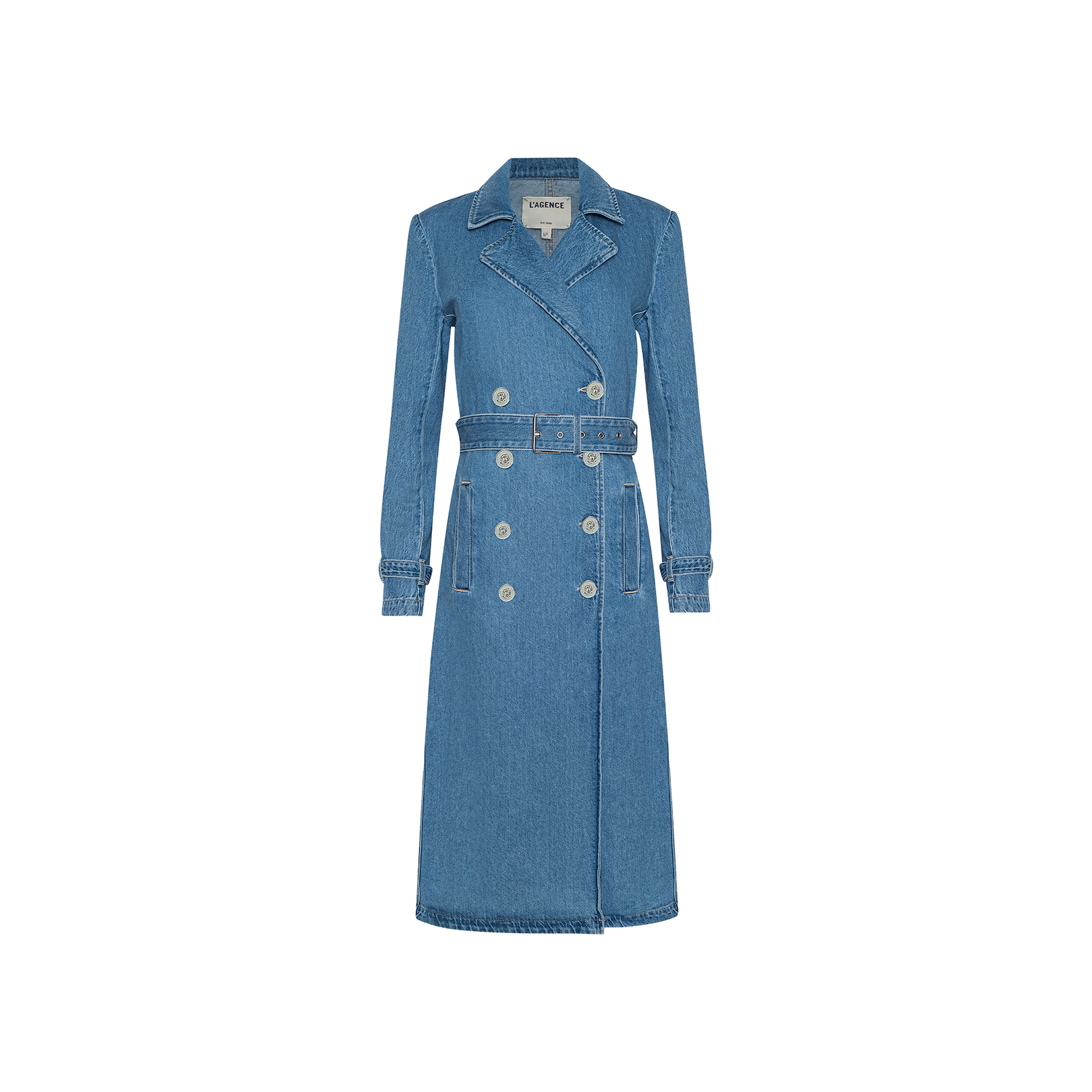 The Bradley Trench Coat is a long blue medium wash denim coat featuring a belt, double-breasted buttons, flap collar, and two front pockets, displayed on a plain white background.