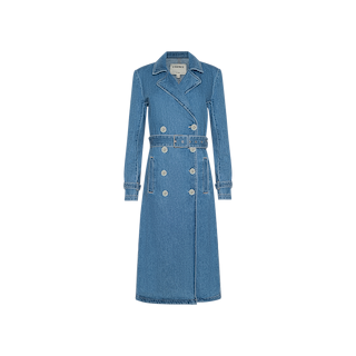 The Bradley Trench Coat is a long blue medium wash denim coat featuring a belt, double-breasted buttons, flap collar, and two front pockets, displayed on a plain white background.