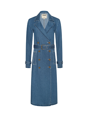The Bradley Trench Coat is a long blue denim trench with a belted waist, double-breasted front with brown buttons, notched lapels, and two front pockets, shown against a white background.