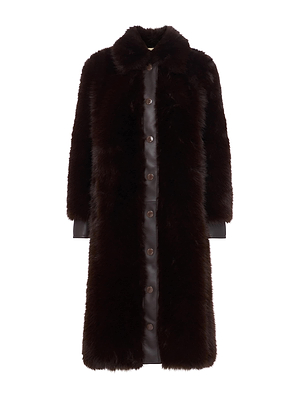 The Irisa Faux Fur Coat by L'AGENCE is a long, dark brown coat in a rich chocolate shade with a wide collar, button-down front, and full-length sleeves. It features a soft, plush texture and an elegant look.