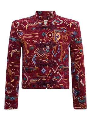 The Asha Jacquard Jacket by L'AGENCE is a cropped tailored piece with a rich red base, multicolored geometric and ikat-inspired patterns, and ornate black toggle closures for a stunning tapestry-inspired look.