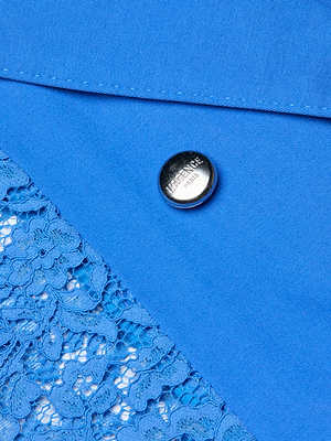 Close-up of the Amata Lace Trench Coat in regatta blue, featuring a decorative floral lace section and a silver BALENCIAGA-engraved button.