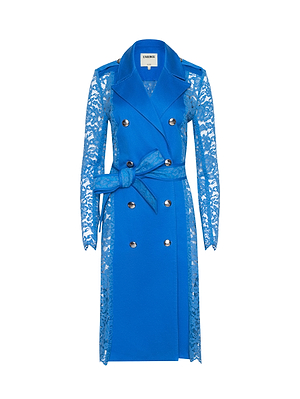 The Amata Lace Trench Coat features a vibrant regatta blue color, floral lace sleeves and sides, double-breasted silver buttons, a wide collar, and a matching belted waist—combining classic style with delicate lace accents.
