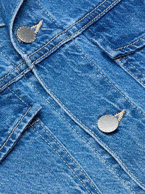 Close-up of the Vianney Jean Jacket in a light wash, highlighting visible stitching and two metallic buttons. The texture of the denim fabric and detailed seam threading are clearly displayed.
