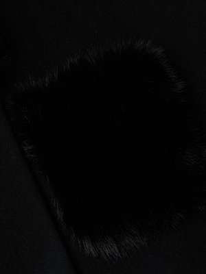 Close-up of the Chana Faux Fur Cape by L'AGENCE, featuring black recycled wool blend fabric with a rectangular patch of soft black faux fur that creates a striking contrast in textures.