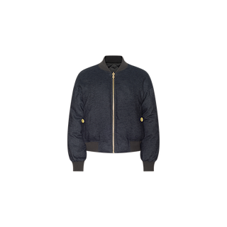 The Violeta Reversible Puffer is a navy blue bomber jacket featuring a gold zipper, ribbed cuffs, collar, and hem, as well as two gold button details on the sides, displayed against a plain white background.