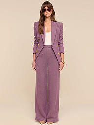 A woman stands facing forward against a plain white background, wearing the Kyomi Double-Breasted Blazer in mauve with gold buttons, paired with a light pink top, sunglasses, and nude heels.