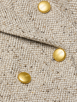 Close-up of the Kyomi Tweed Blazer’s beige Italian wool-blend herringbone fabric, woven with gold metallic threads and detailed with three round, gold LARENCE-engraved buttons—ideal for a double-breasted look.