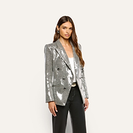 A woman wears a double-breasted, silver sequin Kyomi Sequined Blazer over a white top and black trousers.