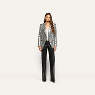 A woman wearing a silver sequined Kyomi Sequined Blazer over a white top and black trousers.