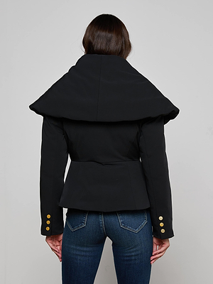 A person with long brown hair is shown from the back, wearing the fitted Pippa High Collar Jacket with a sculptural high collar and gold sleeve buttons, paired with blue jeans.