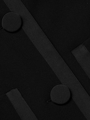 Close-up of the Blythe Cropped Jacket’s black fabric, showing two parallel strips and two round fabric-covered buttons for a textured, monochromatic look.
