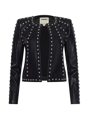 The Fia Studded Leather Jacket is a women's black lambskin jacket with long sleeves, featuring rows of large silver studs along the edges, seams, and shoulders. This open-front piece includes a LAGENCE label inside the neckline.