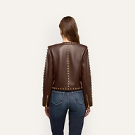 Back view of the chocolate brown Fia Leather Jacket with gold embellishments along the neckline, center back, and sleeves, worn with dark blue jeans.