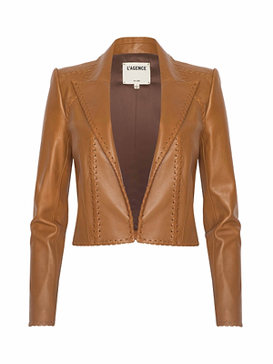 The Dulcie Leather Blazer is a brown cropped jacket featuring long sleeves, an open front, and visible whipstitch detailing along the edges. The label inside reads “L’AGENCE.”.