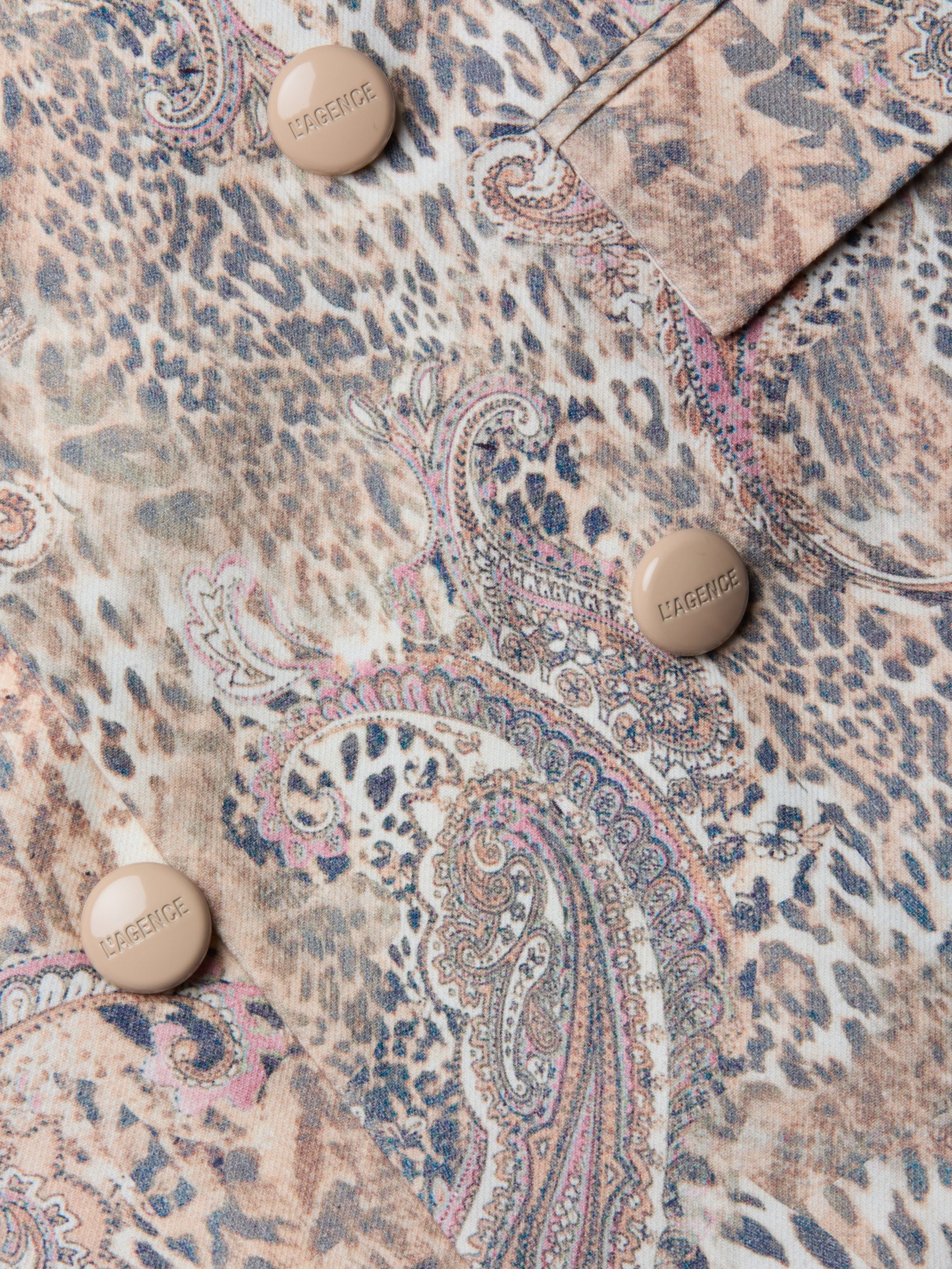 Gros plan sur le blazer Cambrie Oversized Linen-Blend Blazer en paisley léopard beige, marron et rose, avec quatre boutons en relief CARGENIC beige.