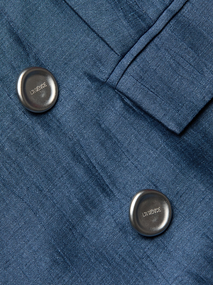 Close-up of the Cambrie Oversized Blazer in blue Italian linen, featuring two large round metallic buttons engraved with 