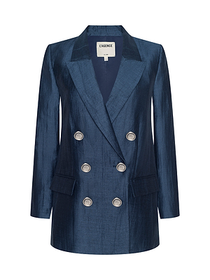 The Cambrie Oversized Blazer is a double-breasted women’s navy blazer by L’AGENCE, featuring silver buttons, two front flap pockets, and a notched collar.
