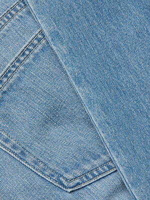 Close-up of the Thalina Cropped Stovepipe Jean in light blue denim, featuring two overlapping pockets with visible stitching and detailed fabric texture.
