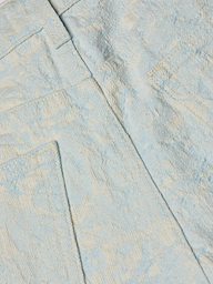 Close-up of light blue cotton jacquard fabric with a subtle pattern, featuring two pockets and seam details, shown on the Lissania Jacquard Short.