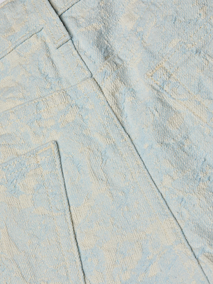 Close-up of light blue cotton jacquard fabric with a subtle pattern, featuring two pockets and seam details, shown on the Lissania Jacquard Short.