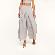 A woman wearing the Ysola Pant—ultra-high rise, wide-leg wool blend trousers in light gray—and beige heels stands against a plain white background. Her face is not visible in the image.