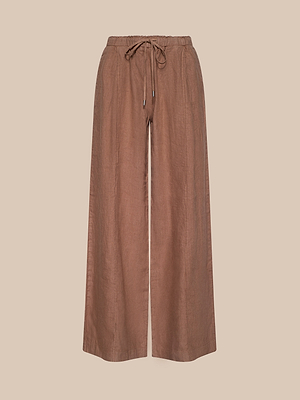The Connie Linen Drawstring Trouser features a wide-leg, high-waisted brown design with an elastic drawstring waistband—ideal for vacations. Shown against a neutral beige background.
