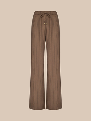 The Connie Drawstring Trouser features a brown wide-leg pinstripe design with subtle vertical stripes, a high rise, elastic waistband, and front drawstring tie, shown against a plain beige background.