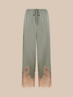 The Mirel Pant features sage green satin, a comfy drawstring waist, and peach lace trim at the hem, shown on a beige background.