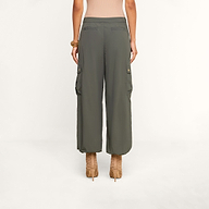 A person wearing the Greer Nylon Jogger in ash olive green and beige high-heeled sandals, standing with their back to the camera against a plain background.