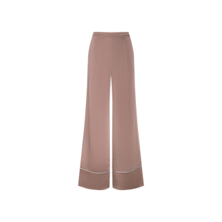 The Tavia Satin Trouser is a high-waisted, wide-leg pant in blush pink satin, featuring a subtle front crease and light blue contrast piping detail near the hem, displayed on a white background.