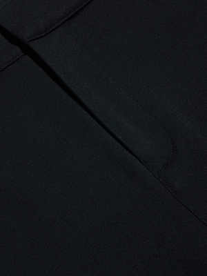 Close-up of the Leni Pedal Pusher’s dark stretch fabric, featuring a seam and folded edge. The material is smooth with slight texture, highlighting quality construction and comfort.