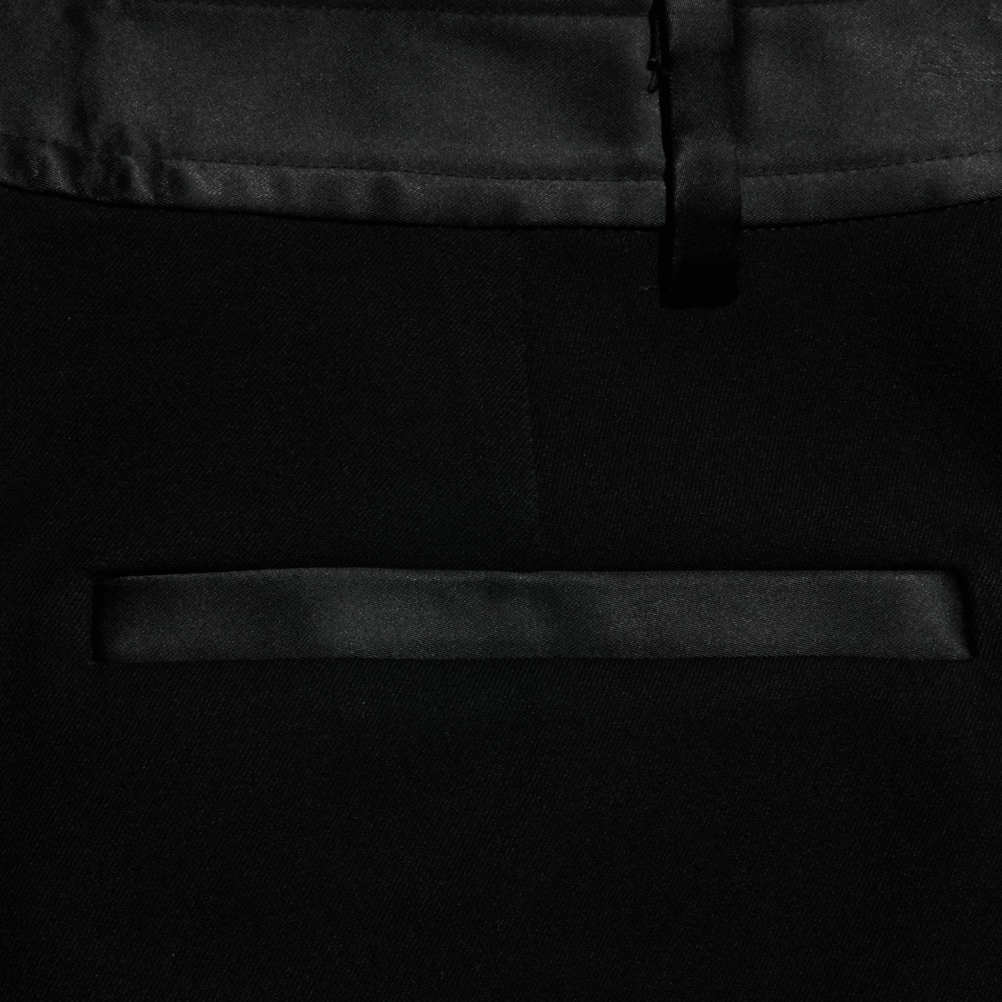 Close-up of the Colt Tuxedo Short in black, featuring a satin trim above the pocket and along the waistband. The image showcases the smooth texture and refined design of the suiting fabric, making it an ideal choice for eveningwear.