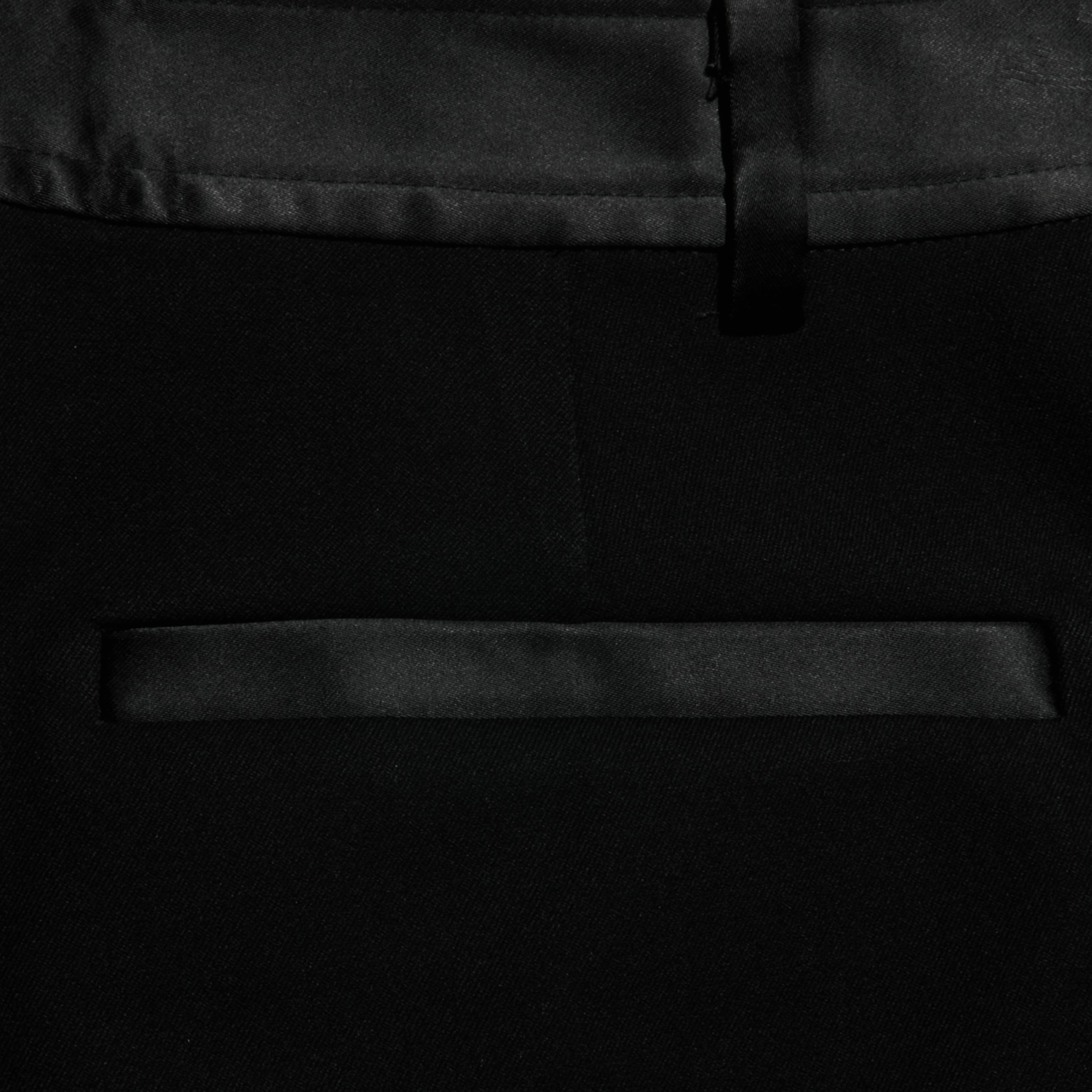 Close-up of the Colt Tuxedo Short in black, featuring a satin trim above the pocket and along the waistband. The image showcases the smooth texture and refined design of the suiting fabric, making it an ideal choice for eveningwear.